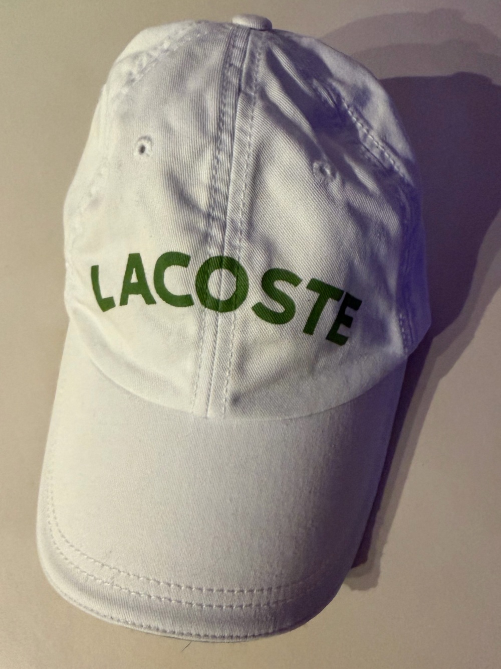 Lacoste White Baseball Cap with Green Logo Lettering. Adjustable fit.
